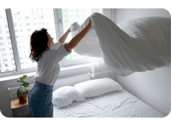 Mulher arrumando a cama