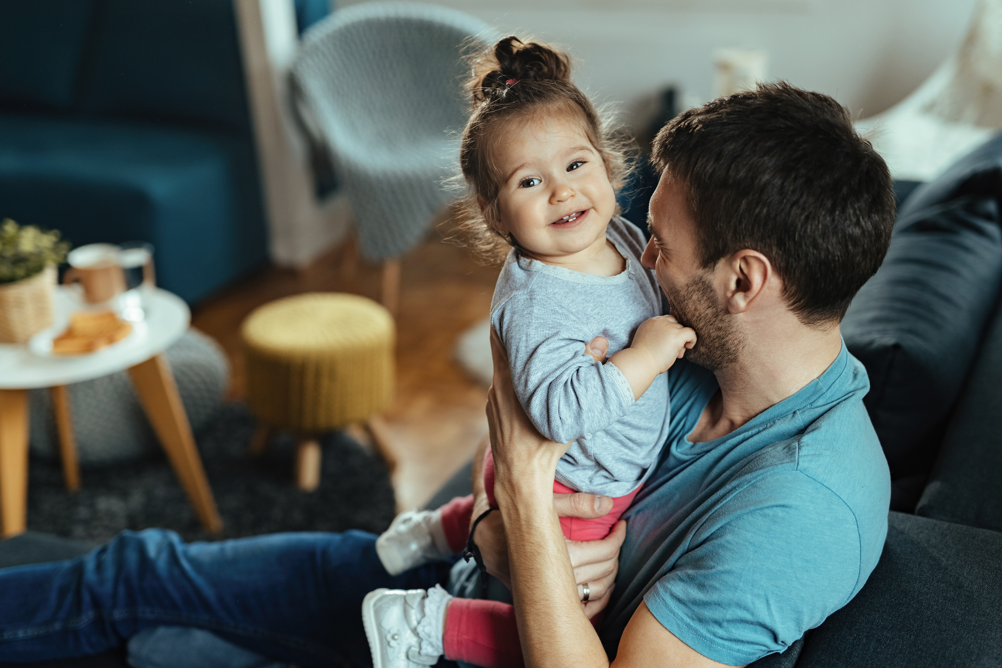 happy-father-and-his-small-daughter-having-fun-together-at-home-focus-is-on-little-girl_Easy-Resize.com