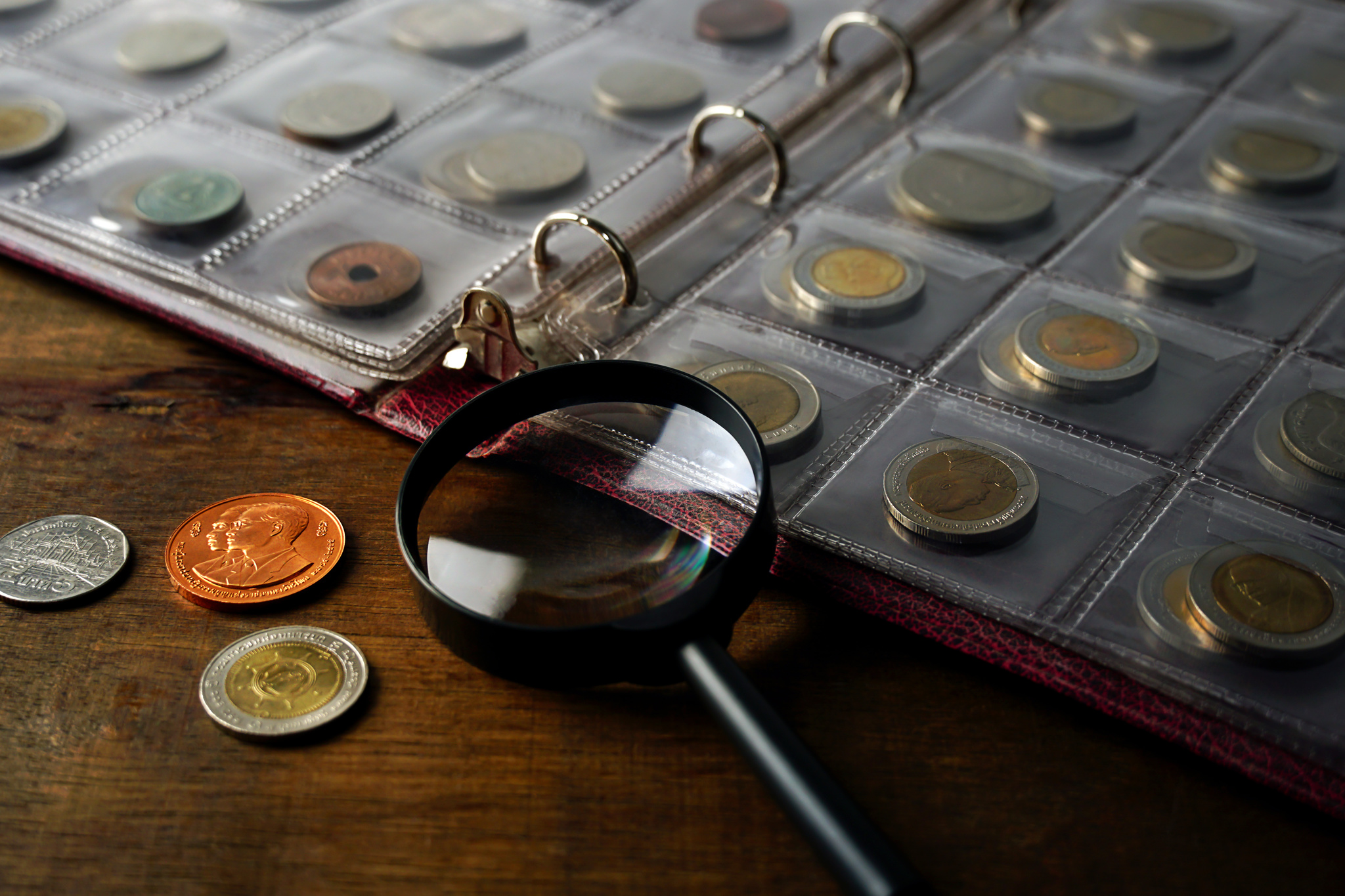 old-collectible-coins-on-wooden-table-dark-background-banner-numismatics-coins-in-the-album_Easy-Resize.com