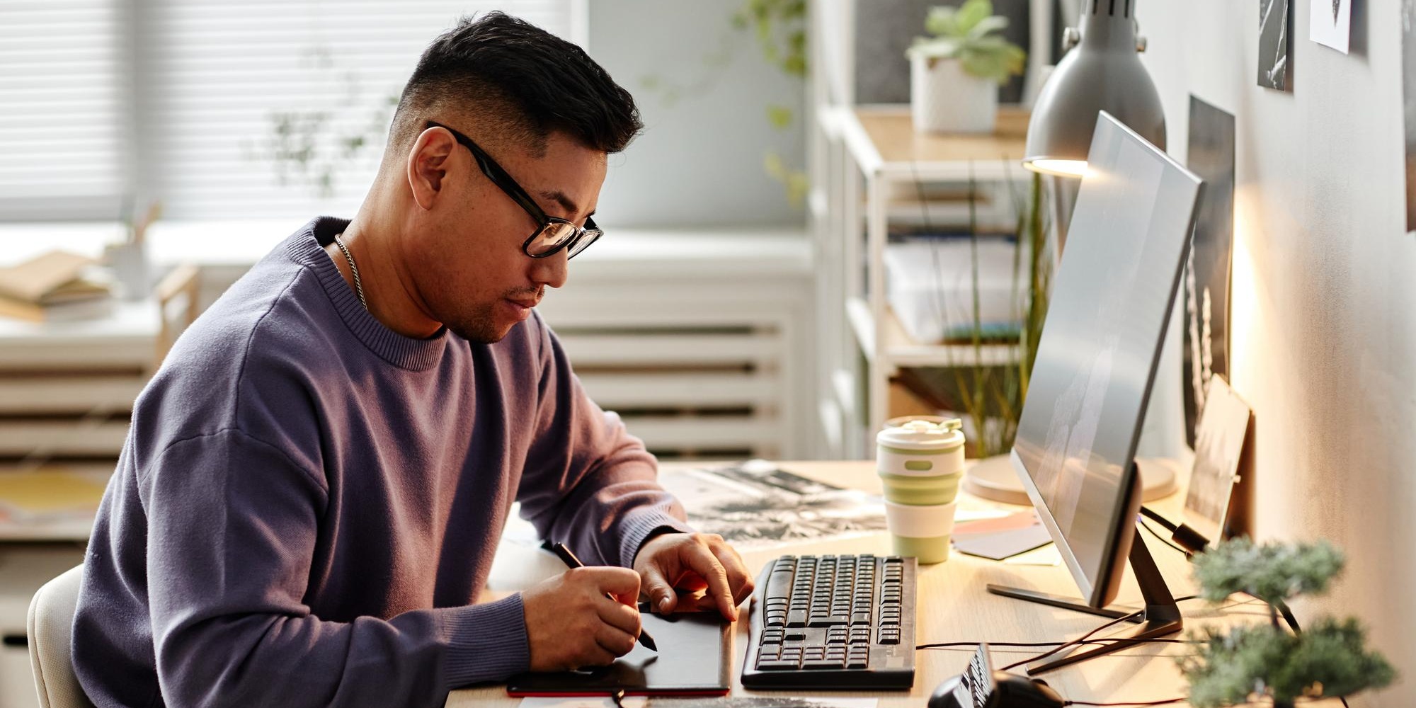 portrait-of-asian-male-creator-retouching-photographs-at-home-office-workplace-and-using-pen-tablet (1)